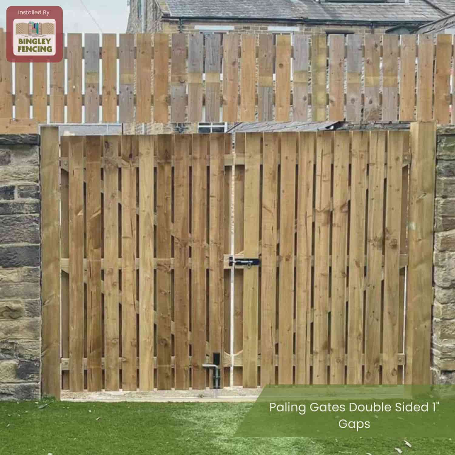 A Bingley Fencing “Paling Gates Double Sided 2" Gaps - Flat Top & Arched Top” is installed between stone pillars with extra slats above, set before a green lawn. The Bingley Fencing sign is in the upper left corner.
