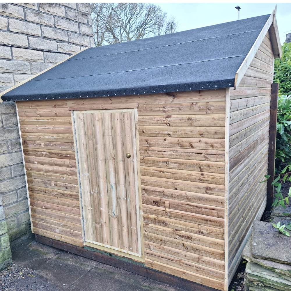 Hipex shaped shed with two doors and sloped roof.