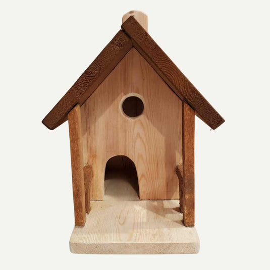The Bingley Fencing Bird House is a handmade wood piece with a pitched roof, round entrance above an arched opening, and flat base, all in natural tones.