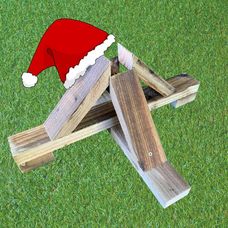 Load image into Gallery viewer, On a grassy surface, a collection of wooden planks sourced sustainably is arranged in an abstract shape resembling the letter A. To enhance its festive appeal, a digital Santa hat is added to the top corner of the planks, evoking the spirit of Nordman Christmas Trees by Bingley Fencing.