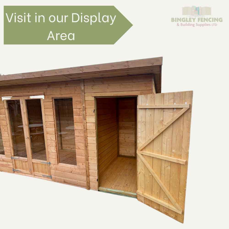 Load image into Gallery viewer, The Shed-Summerhouse Combination by Bingley Fencing, shown with open door and large windows on a light background, features a green sign saying Visit in our Display Area. Ideal as a custom summerhouse. The top right corner displays the Bingley Fencing logo.