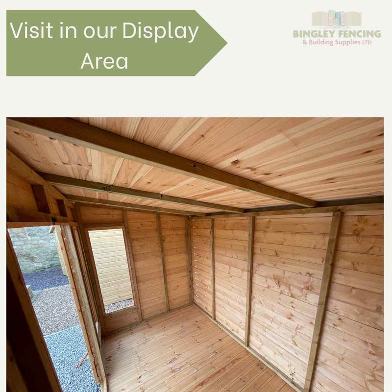 Load image into Gallery viewer, Interior view of a custom Shed-Summerhouse Combination by Bingley Fencing, featuring light brown panels and a pitched roof. The empty structure is illuminated by natural light through an open door. Text reads, Visit in our Display Area next to the Bingley Fencing logo.