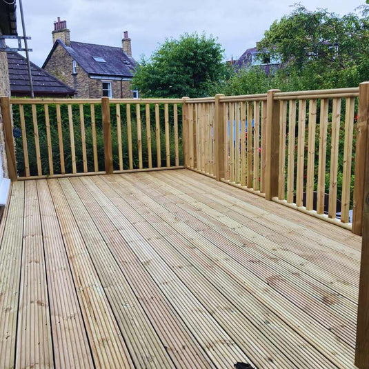 Wooden decked area with vertical balusters and handrail