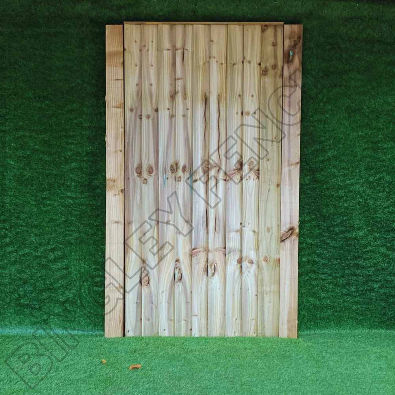 Load image into Gallery viewer, A wooden fence panel with vertical planks stands against a green backdrop, subtly displaying the words BINGLEY FENCING. Enhance your outdoor space with our Featheredge Gates available in Flat Top and Arched Top designs or explore our bespoke size gate options for seamless integration and style.