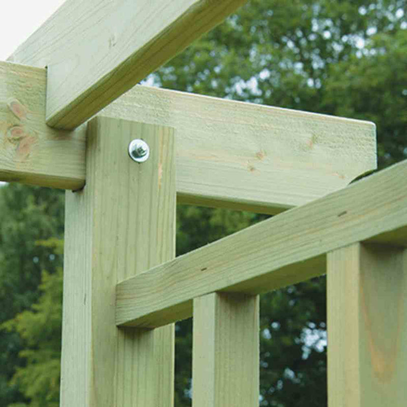 Load image into Gallery viewer, Close-up of the KDM Reduced Flat Top Arch crafted from tanalised softwood, displaying connected beams and a bolt, with green trees softly blurred in the background—ideal for strong, lasting garden structures.
