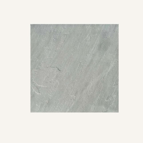 The Kandla Grey Indian Sandstone Individual Paving Slabs by Bingley Fencing feature a light gray, textured surface with subtle wavy diagonal patterns, evoking the look of authentic Indian sandstone on an off-white base.