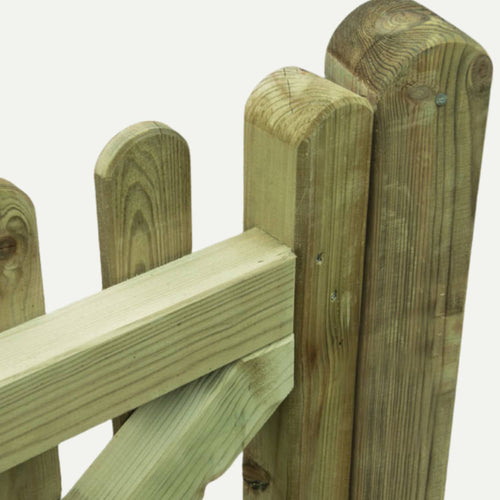 Close-up of the KDM Premium Round Top Picket Gate - PPG90, featuring vertical planks, a diagonal support beam, and visible wood grain. The pressure treated gate has a light, unfinished look that showcases quality timber.
