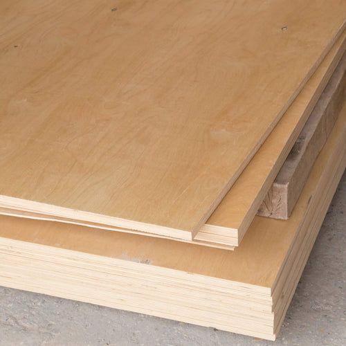 A close-up of stacked Bingley Fencing Sheet Material - Plywood (8ft x 4ft, Class 2&3) on a concrete floor, highlighting the smooth, light wood surface and layered edges in various thicknesses.