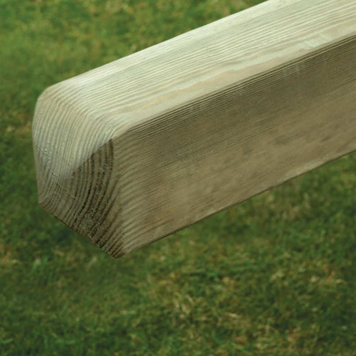 A close-up of a KDM Smooth Planed European Gate Post—4"x4" PAR (3.5"x3.5"/90x90mm)—with rounded edges, set against a grassy outdoor background.