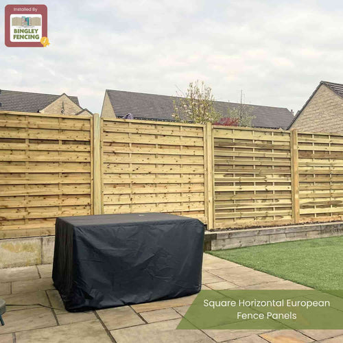 A neatly installed KDM Square Horizontal Fence Panel (SH) with solid horizontal slats in a backyard featuring stone paving, artificial grass, a covered outdoor item, and houses beyond. Logo: “Bingley Fencing.”.