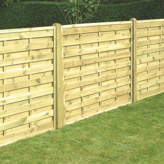 KDM's Square Horizontal Fence Panels (SH), featuring a horizontal slat design supported by vertical posts, stand on a neatly trimmed green lawn with shrubbery in the background.