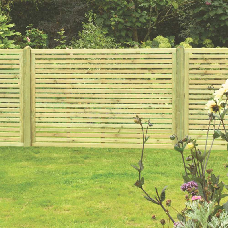Load image into Gallery viewer, The KDM Slatted Fence Panels feature a contemporary design that enhances the gardens privacy and security, while vibrant green grass and colorful flowers complement leafy shrubs, creating a picturesque backdrop.