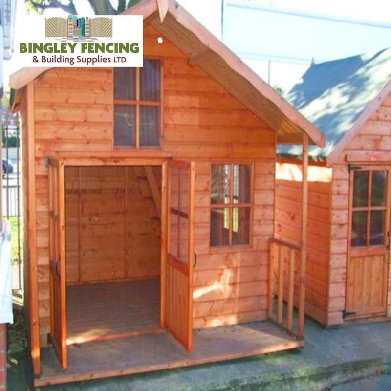 Load image into Gallery viewer, The Adventure Kids Playhouse by Bingley Fencing showcases an inviting open front door and a cozy small porch. Constructed with child-friendly preservatives, the playhouse boasts a pitched roof and a window above the entrance. A sign indicating Bingley Fencing & Building Supplies LTD graces the top of the structure.