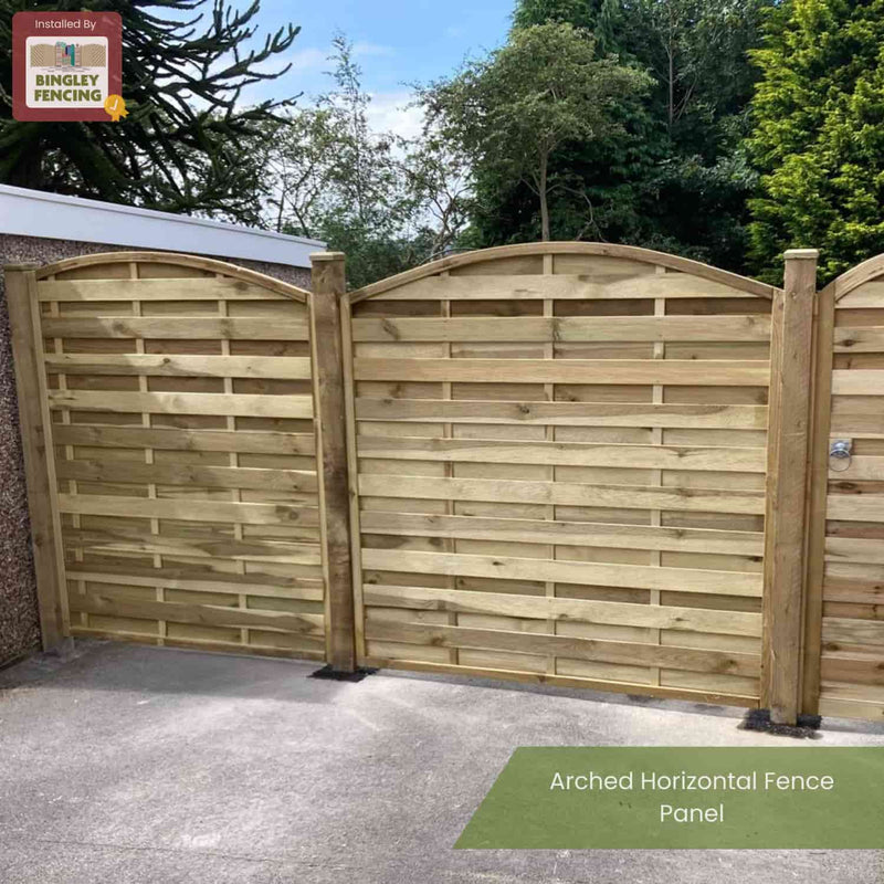 Load image into Gallery viewer, A wooden KDM Arched Horizontal Fence Panel - AH180 made from pressure-treated timber features arched horizontal panels, installed in a lush garden. The top left shows the KDM logo; below, the text reads Arched Horizontal Fence Panel - AH180.