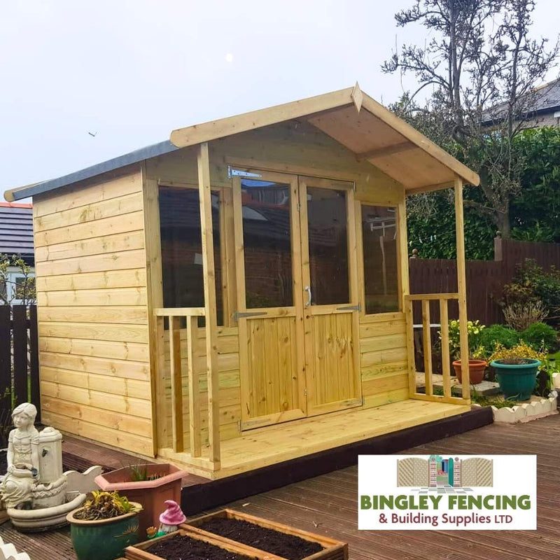 Load image into Gallery viewer, An Apex Summerhouse with a pitched roof and double doors is situated on a wooden deck, encircled by planters and a small statue. The Devon Range signifies its quality, featuring the Bingley Fencing logo in the bottom right corner.