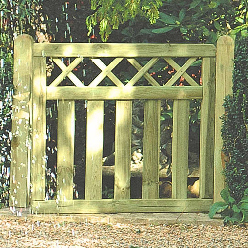 A wooden garden gate with a cross top border design, set against a natural background.