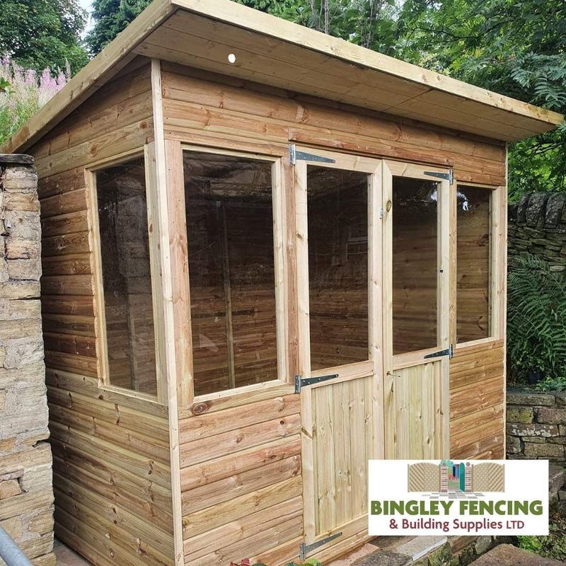 Load image into Gallery viewer, Nestled in a garden surrounded by trees, the Pent Summerhouse by Bingley Fencing features a sloped roof and a front door with glass panels, exuding elegance and charm. In the bottom right corner, the Bingley Fencing & Building Supplies LTD logo showcases their savvy payment plan option.