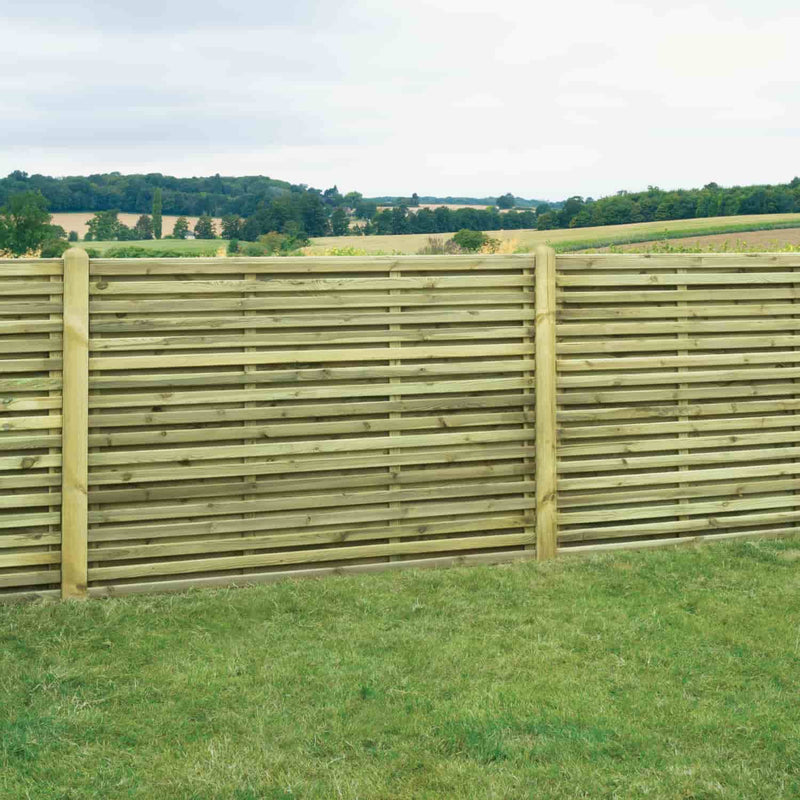 Load image into Gallery viewer, The KDM Double Sided Slatted Panels (SDS180) are shown installed on green grass, with countryside hills and trees in the background beneath a cloudy sky.