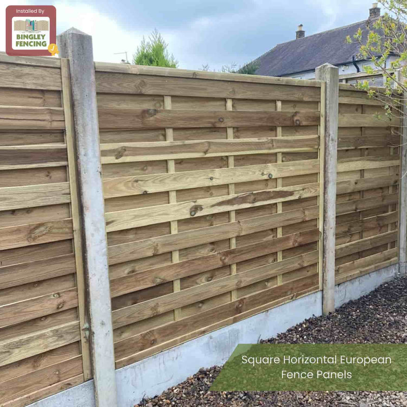 Load image into Gallery viewer, A wooden fence features KDM Square Horizontal European Fence Panels set between concrete posts, alongside a gravel garden area. The Bingley Fencing logo is displayed in the top left corner.