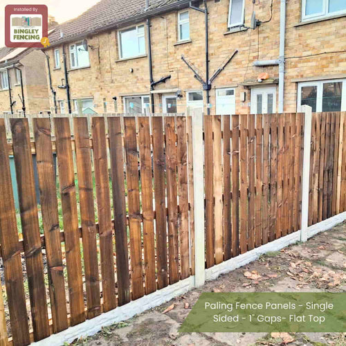 Paling Fence Panels - Single Sided - 1 Gaps - Flat Top by Bingley Fencing line the backyard edge of a brick house. These made-to-measure, pressure-treated panels feature a sign reading Installed by Bingley Fencing.