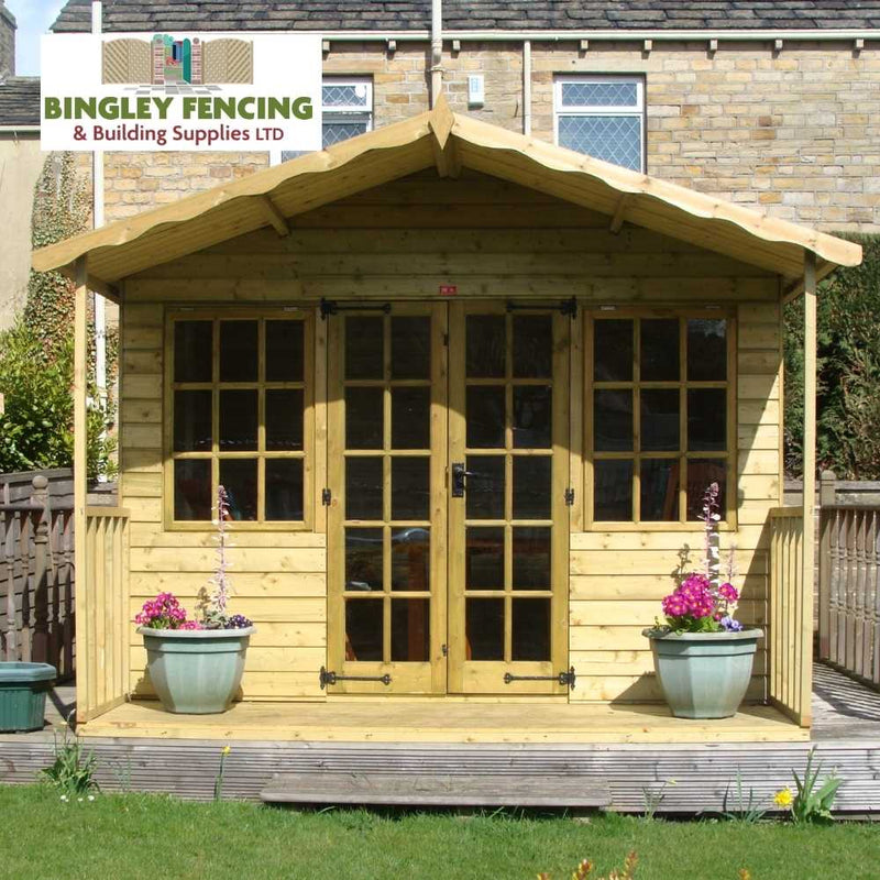 Load image into Gallery viewer, A Georgian Summerhouse, crafted by Bingley Fencing, features prominently with its large glass doors framed by two vibrant potted plants. The elegant structure is set against a backdrop of a brick house and wooden fence. Above, the signage reads Bingley Fencing & Building Supplies LTD.