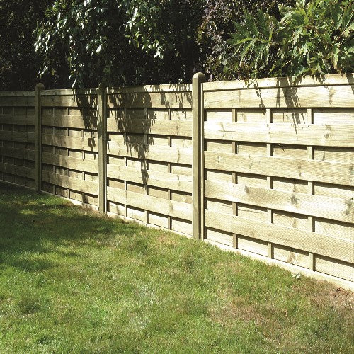 KDMs Square Horizontal European Fence Panels enhance privacy and security with their wooden design. Set among greenery and trees, this pressure-treated fence separates the garden from foliage along a neatly trimmed grassy area.