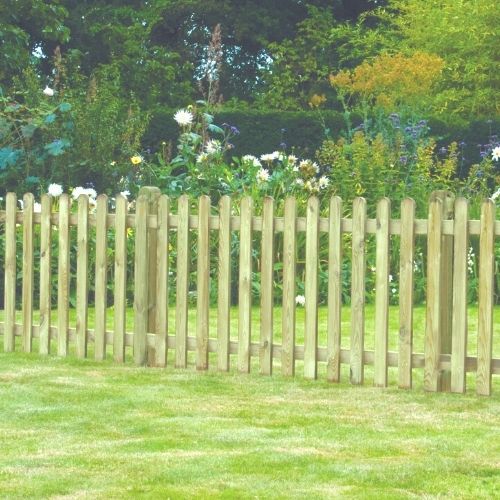 Load image into Gallery viewer, A KDM Round Top Picket Gate (RTPG120) enhances the wooden picket fence in front of a vibrant garden full of colorful flowers and greenery. The neatly trimmed grass adds to the serene and welcoming landscape.