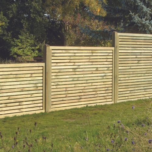 Load image into Gallery viewer, The contemporary design of the KDM Slatted Fence Panels enhances the garden setting, surrounded by lush green grass and vegetation. These European fence panels provide both privacy and security, with trees and shrubs in the background under a clear sky.