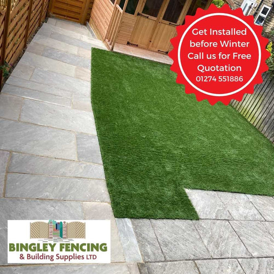 Paved patio area in indian paving stone with a small grassed area and summerhouse