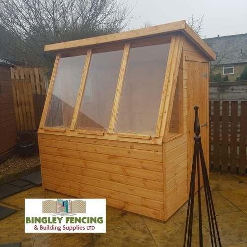 wooden shed with extra large windows and internal wooden shelves