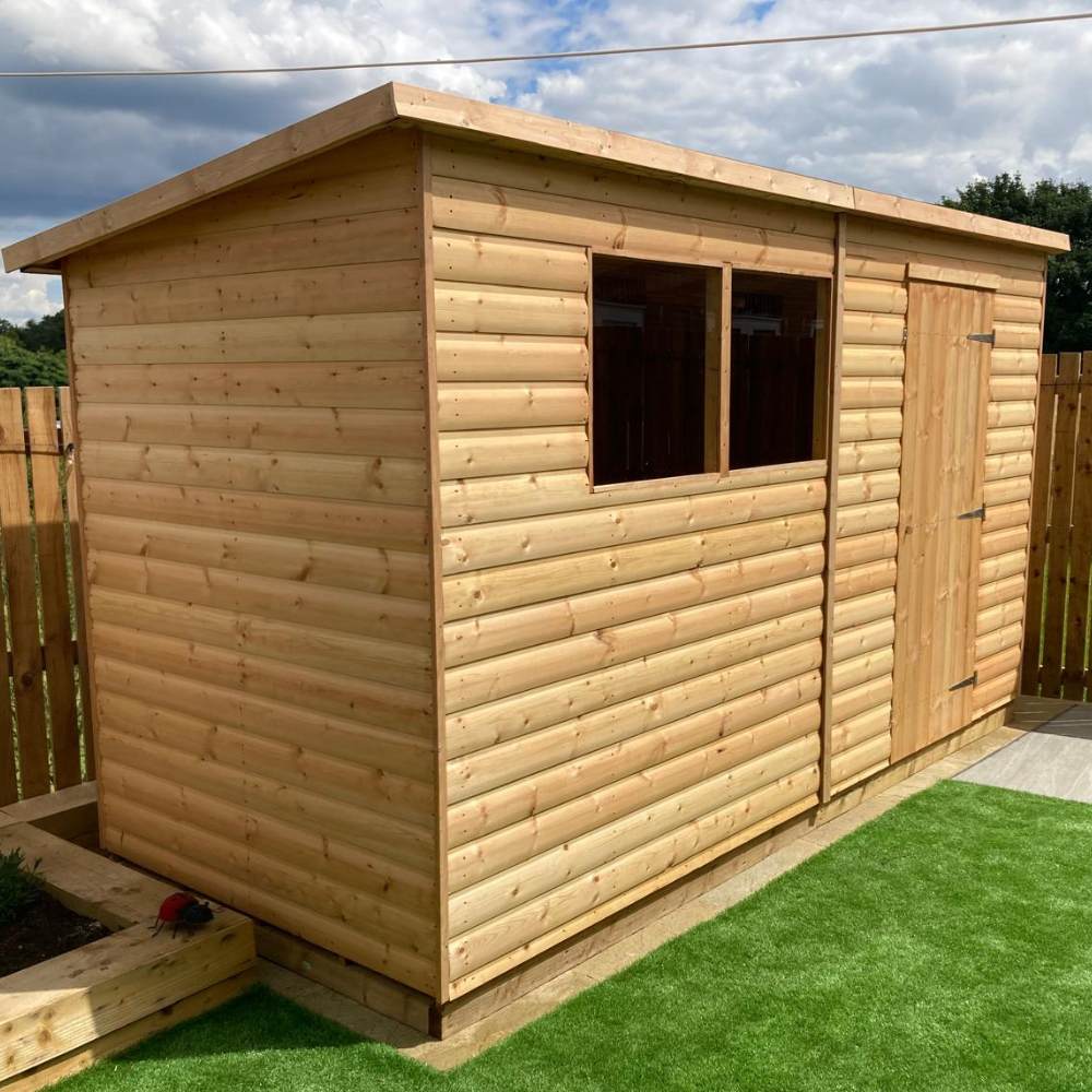 Wooden garden shed installed on artificial grass garden