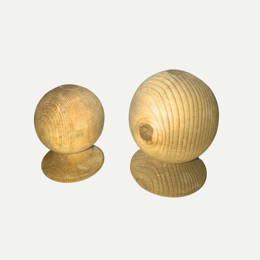 Two round, unfinished KDM Ball Finial wooden spheres—each mounted on a flat wooden base—are displayed against a plain white background. Ideal as classic fence post finials, they perfectly complement your decking accessories or outdoor spaces constructed with pressure treated timber.