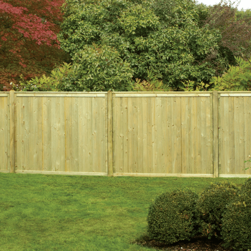 Load image into Gallery viewer, A wooden privacy fence featuring KDM&#39;s Tongue &amp; Groove European Fence Panels with a flat top surrounds a green lawn, set against a backdrop of dense shrubs and vibrant trees.
