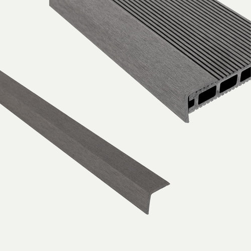 Two gray L-shaped deX Classic Composite Decking edge trims by Bingley Fencing—one solid and one with grooves and hollow sections—are displayed on a plain white background.