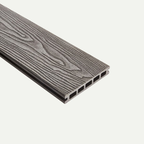 A single deX Classic Composite Decking Board by Bingley Fencing, shown in gray with a wood grain texture and hollow rectangular channels running lengthwise, is displayed on a white background. This reversible 3.6m board offers a stylish and low-maintenance decking solution ideal for modern outdoor spaces.
