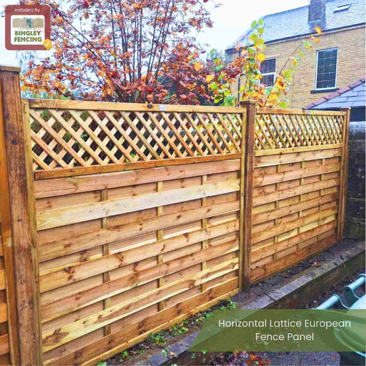 The KDM Horizontal Lattice European Fence Panel features horizontal panels and a lattice top, shown outdoors near autumn trees and a brick building.