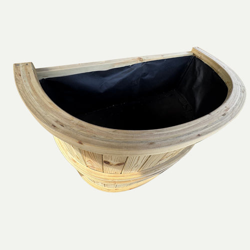 The KDM Half Moon Garden Planter - HMP, crafted from pressure treated timber with a black fabric liner, is shown from an angled top view on a white background—ideal for durable garden planting in West Yorkshire.