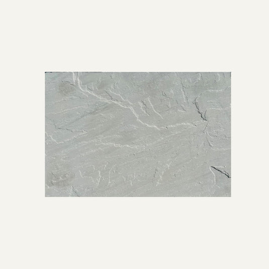 A Kandla Grey Indian Sandstone Individual Paving Slab from Bingley Fencing displays fine white veining and textured patterns, set against a plain off-white background.