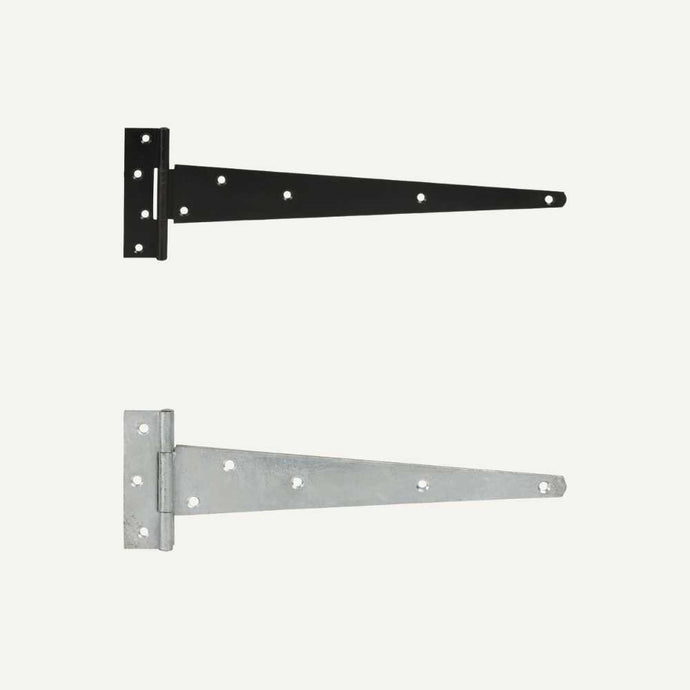 Two Henry Shaw Medium T Hinges, one powder-coated black and the other in galvanized silver. Each hinge features a rectangular plate with multiple screw holes and a tapered arm extending to the right. Perfect for gate ironmongery, they create a striking contrast against the light gray background.