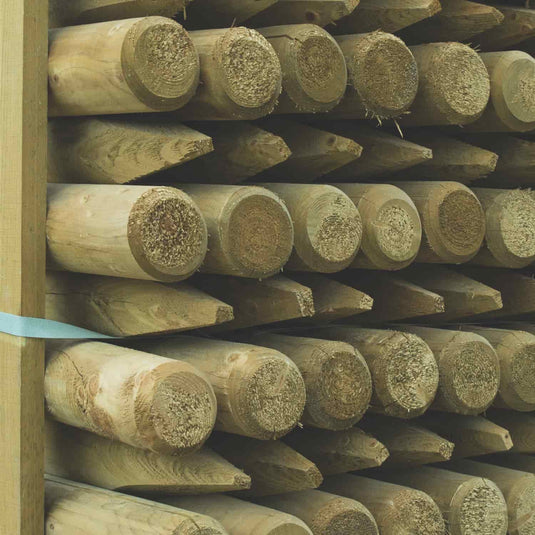 A stack of Bingley Fencing's Tree Stake - Machine Round Spiked Fence Posts, measuring 3 inches in diameter and 8 feet in length, is neatly arranged in multiple horizontal rows, secured with a blue strap. The ends of the posts are visible, displaying circular cross-sections. Crafted from tanalised treated wood, the surface appears smooth and uniform in color.
