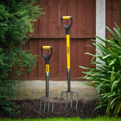 Two Roughneck - Micro Fork 29″ garden tools with yellow handles standing upright in soil.