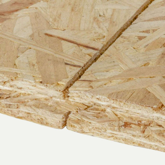Close-up of a stack of Bingley Fencing 18mm OSB Tongue & Groove Flooring Sheets, ideal for load-bearing applications. The rough, layered texture reveals visible wood strands and natural color variations, with a cut edge in the foreground perfect for installations like OSB3 Flooring.