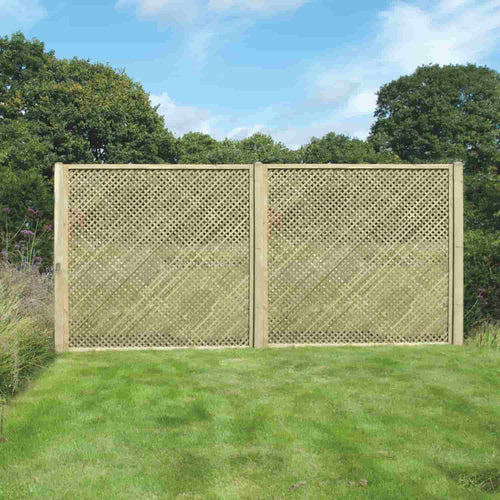 Two KDM Trellis - Privacy Lattice panels (Rectangle 180cm x 183cm, PL13) stand side by side on a mowed lawn, supporting climbing plants with green trees and a blue sky behind them.