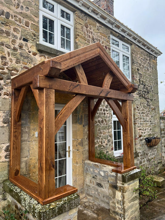 Solid Oak Entrance Porch on a house. With solid oak cross beams supplied and installed in Bradford