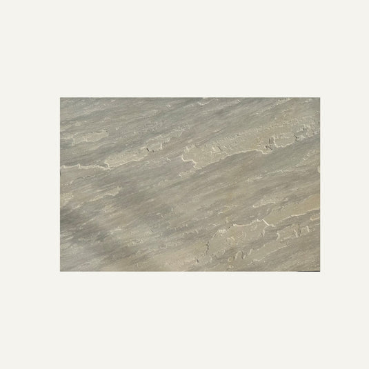 Close-up of Raj Green Indian Sandstone Paving Slabs by Bingley Fencing, featuring beige and gray diagonal streaks, natural patterns, and textured surface on a plain white background—perfect for paving or calibrated slabs.