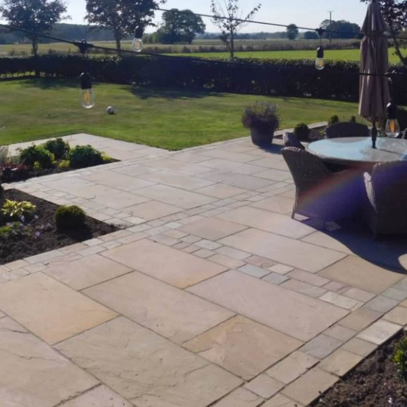 Load image into Gallery viewer, Paved patio area with outdoor furniture and garden in the background
