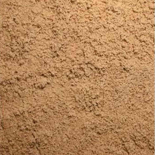 A close-up photo captures a pile of Sharp Sand with a coarse, grainy texture reminiscent of brown sugar. The sand is loosely packed, filling the entire frame and showcasing its natural color and granules.
