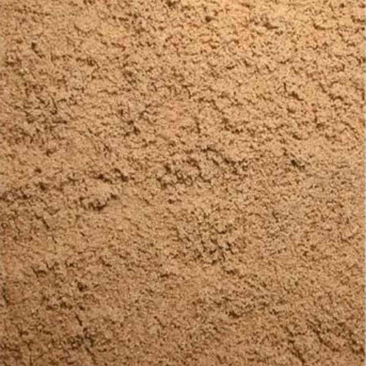 A close-up photo captures a pile of Sharp Sand with a coarse, grainy texture reminiscent of brown sugar. The sand is loosely packed, filling the entire frame and showcasing its natural color and granules.