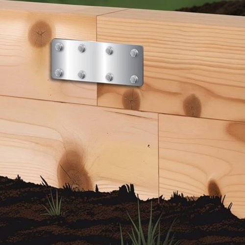 The John George Sleeper Support Plate for Timber Sleepers, secured with six screws, fastens two wooden boards in a garden bed, ensuring sturdy sleeper support with soil and grass visible below.