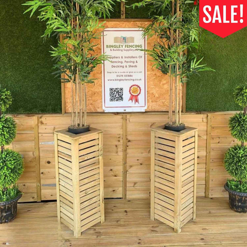 Load image into Gallery viewer, Two KDM Tall Slatted Timber Planter 300mm x 300mm x 800mm – Clearance units, each containing a faux bamboo plant, with a red sale badge in the corner.
